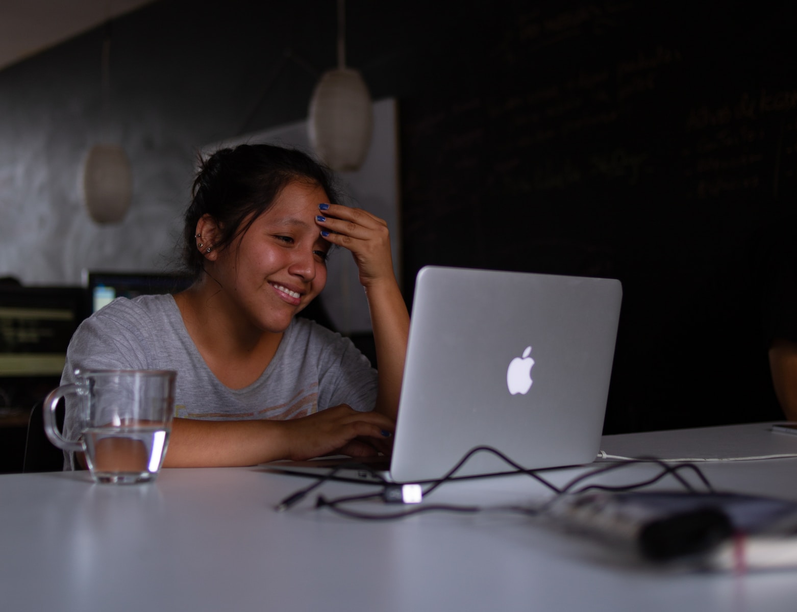 smiling woman using MacBook