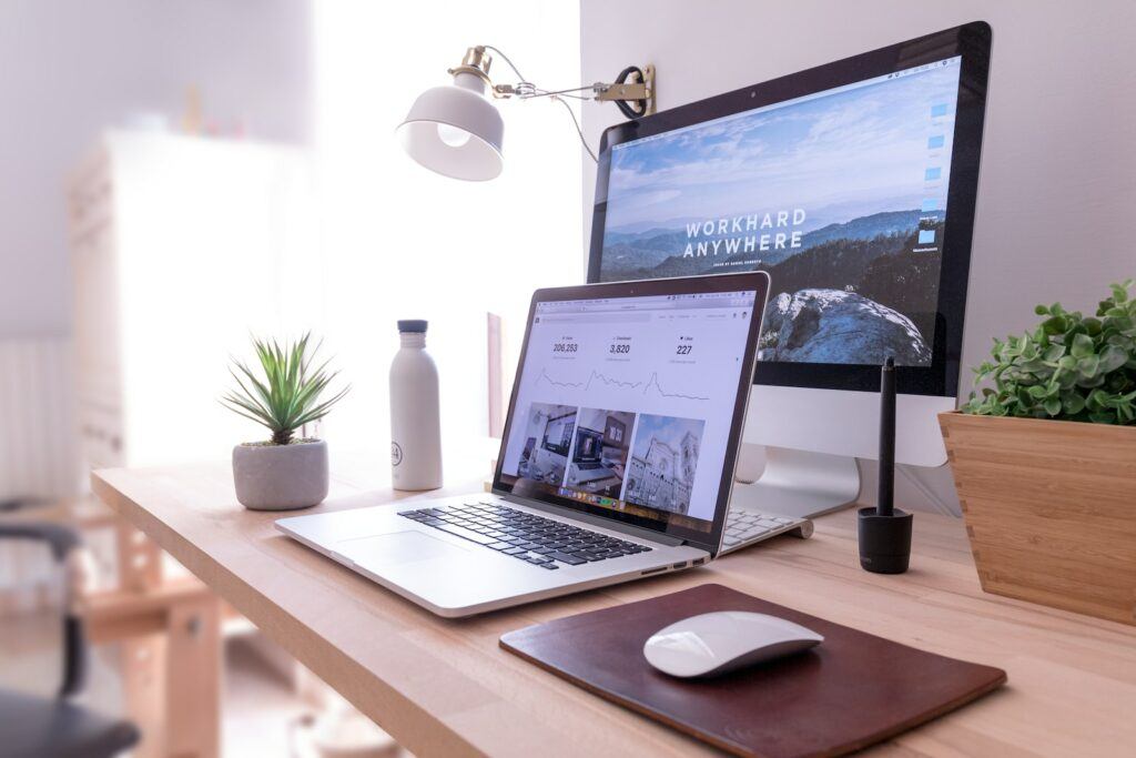 How to Get Into Tech - MacBook Pro on table beside white iMac and Magic Mouse 